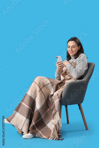 Young woman with plaid usin...