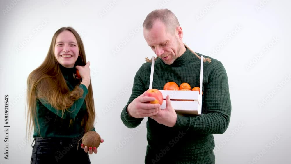 comic photo different size of breasts one breast is larger than the other is smaller girl holding fruit tangerine and cocoas smiling man next to a basket in form of box looks at teenage joke instead comic photo different size of breasts one breast is larger than the other is smaller girl holding fruit tangerine and cocoas smiling man next to a basket in form of box looks at teenage joke instead