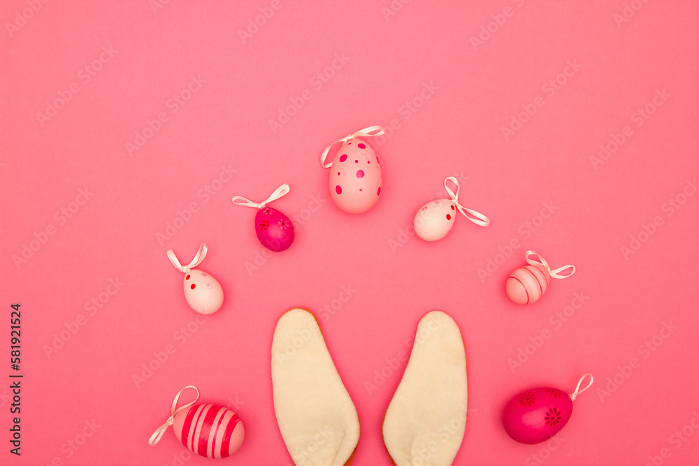 Celebrate Easter with a pink background that includes copy space, Easter eggs, and bunny ears Celebrate Easter with a pink background that includes copy space, Easter eggs, and bunny ears