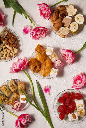 oriental sweets on a light background with pink tulips