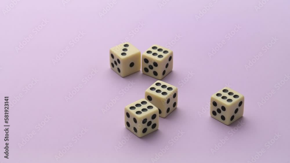 Hand throwing five dice almost getting four sixes
Hand throwing five dice almost getting four sixes
