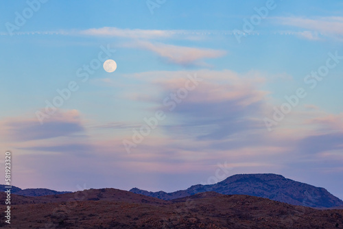 Sunset landscape with a full moon in Wichita Mountains National Wildlife Refuge