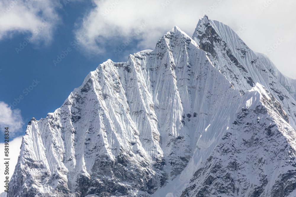 Naklejka premium Impressive wall of Thamserku (6608m) seen during acclimatization hike above Thame