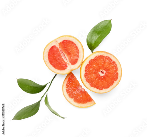Composition with cut juicy grapefruit and plant leaves on white background