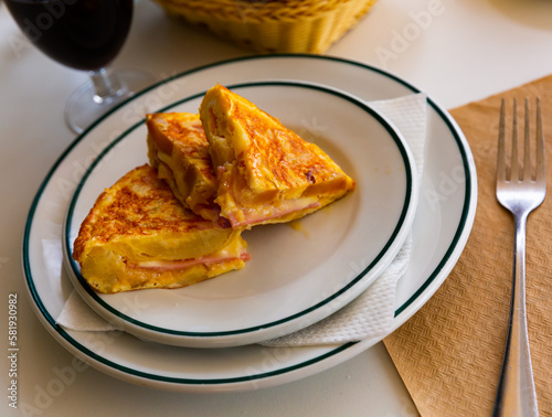 Traditional Spanish tortilla with ham on a white plate