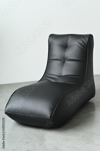Black leather chaise longue on a white background.