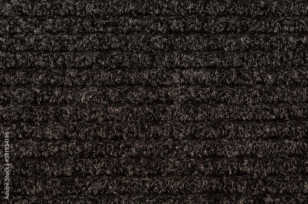 Fototapeta premium Black door carpet with horizontal stripes as background texture