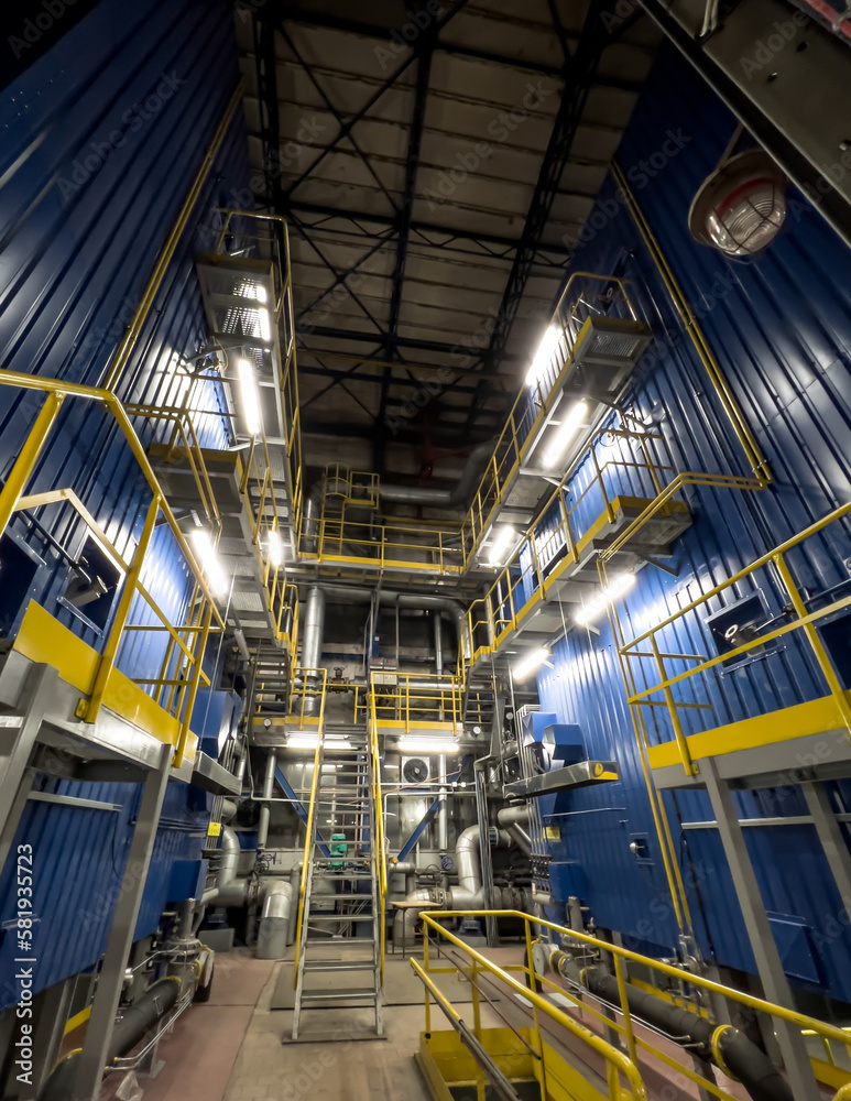 Side walls of two water district heating boilers fired with natural gas after modernization. Fittings at the boilers.