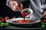 Red sauce is being added by the chef to the toned appetizer of vegetables and berries. Generative AI