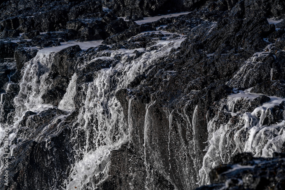 Black rocks on the coast of Iceland with big waves Black rocks on the coast of Iceland with big waves