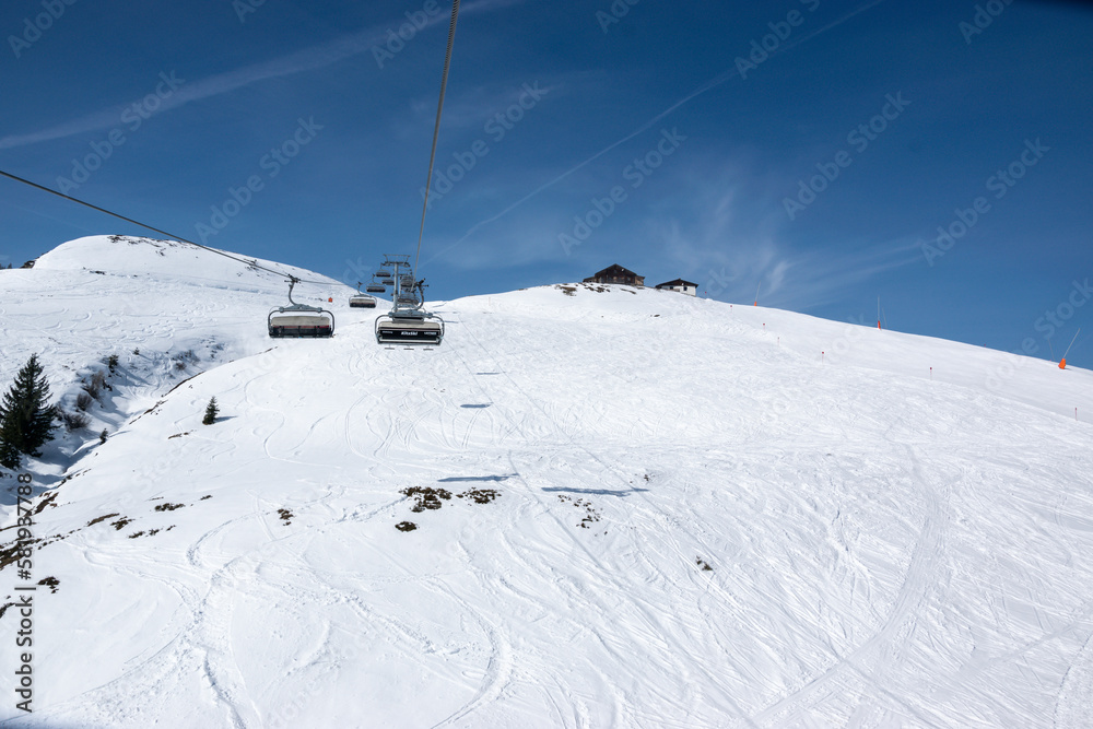 Pass Thurn, Austria - Chair lift for skiers goes up the snowy hill in winter.