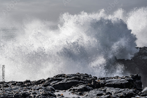 Black rocks on the coast of Iceland with big waves