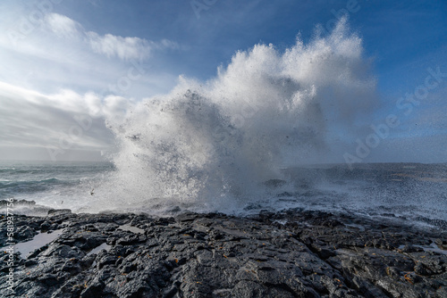 Black rocks on the coast of Iceland with big waves