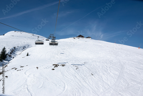 Pass Thurn, Austria - Chair lift for skiers goes up the snowy hill in winter.