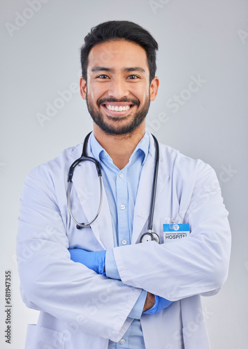 Doctor, happy man and portrait in a studio with a smile from success, motivation and stethoscope. Happiness, medical consultant and hospital worker with gray background smiling about health vision