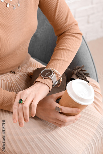 Obraz na płótnie Woman with stylish wristwatch and cup of coffee sitting at home, closeup