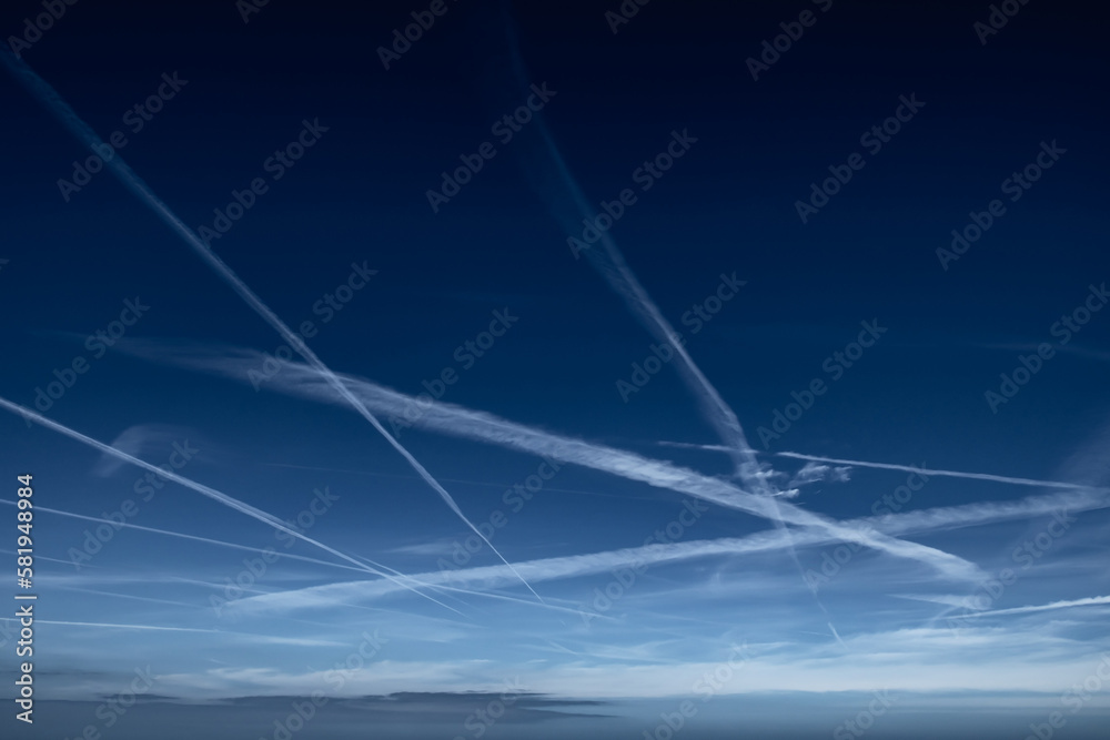 Blue Sky With Grid Of White Condensation Trails, Contrails, From Airplane  Stock Photo | Adobe Stock