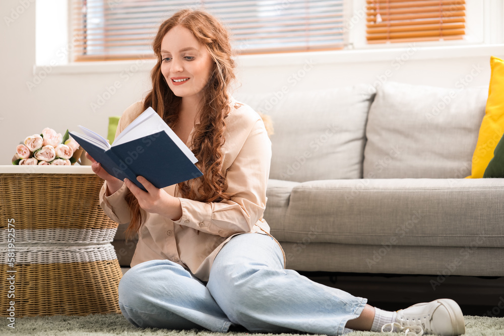 Beautiful redhead woman reading book at home Beautiful redhead woman reading book at home