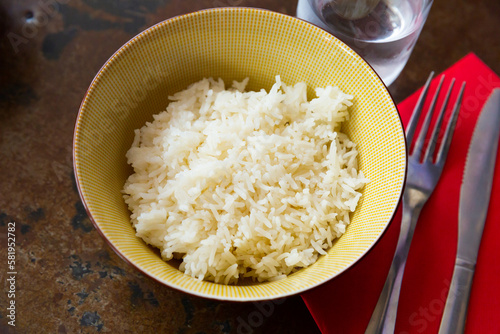 Cooked white rice in bowl closeup, food concept