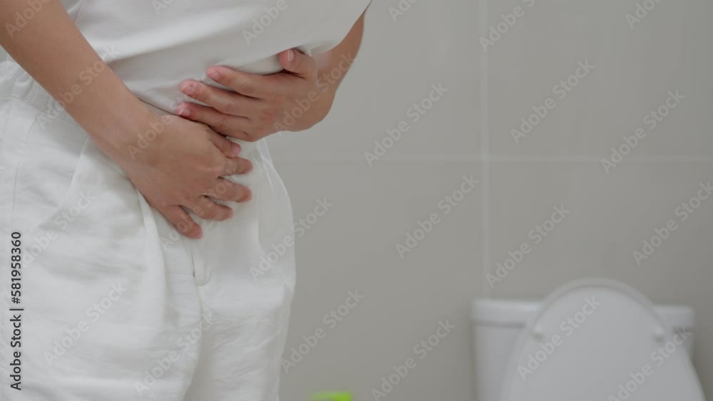 Constipation and diarrhea in bathroom. Hurt woman touch belly stomach