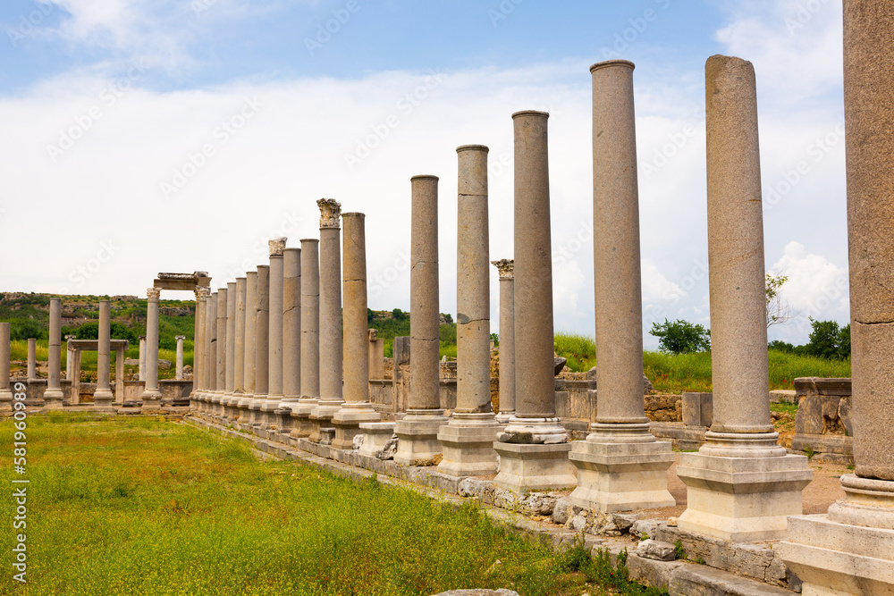 View of remains of stone Ionic columns of Agora in ancient Greek settlement of Perga in Anatolia on spring day. Historical sights and archaeological sites of Turkey