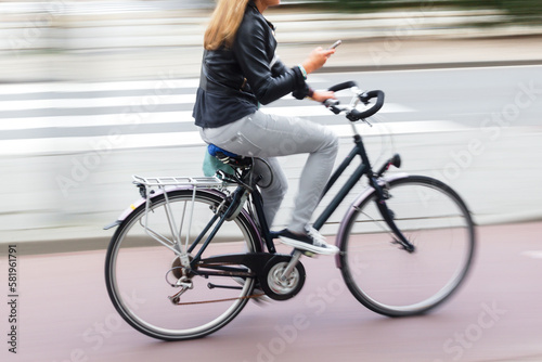 young woman with a bicycle on the move in the city