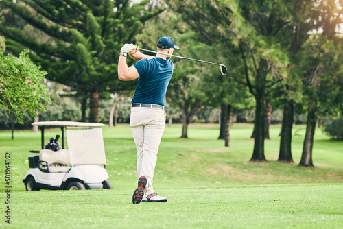 Golf, stroke and focus with a sports man swinging a club on a field or course for recreation and fun. Golfing, grass and training with a male golfer playing a game on a green during summer