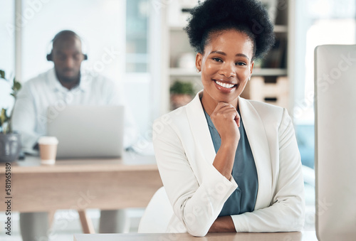 Happy, success and portrait of a businesswoman in the office with a computer working on a project. Happiness, smile and African female corporate manager sitting at her desk with a pc in workplace.
