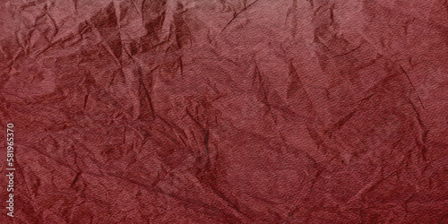 Burgundy textured paper for backgrounds, banners and web elements. Dark red crumpled texture. 