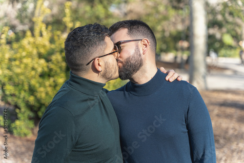 gay couple in the park, with sunglasses, affectionate and playful