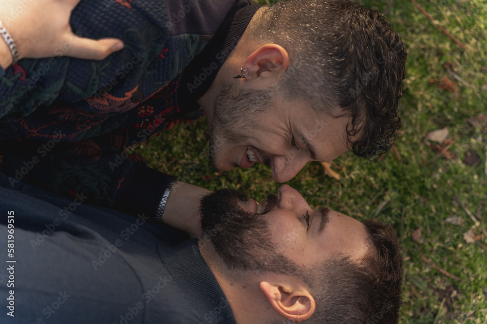 gay couple in the park, cuddling, loving and playful