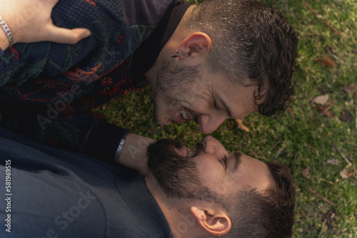 gay couple in the park, cuddling, loving and playful