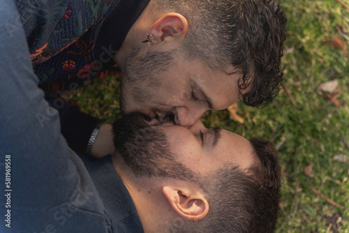 gay couple in the park, cuddling, loving and playful