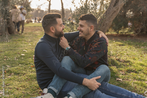 gay couple in the park, cuddling, loving and playful