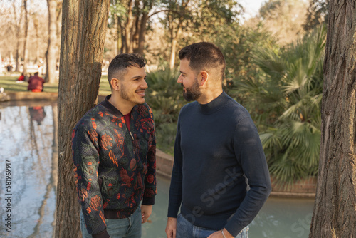 gay couple in the park, cuddling, loving and playful