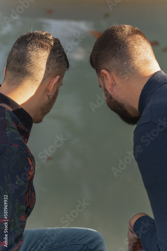 gay couple in the park, walking happily, loving and playful
