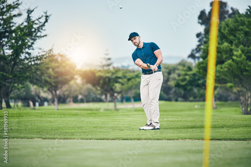 Golf, stroke and aim with a sports man swinging a club on a field or course for recreation, fun and hobby. Golfing, grass and training with a male golfer playing a game on a green during summer