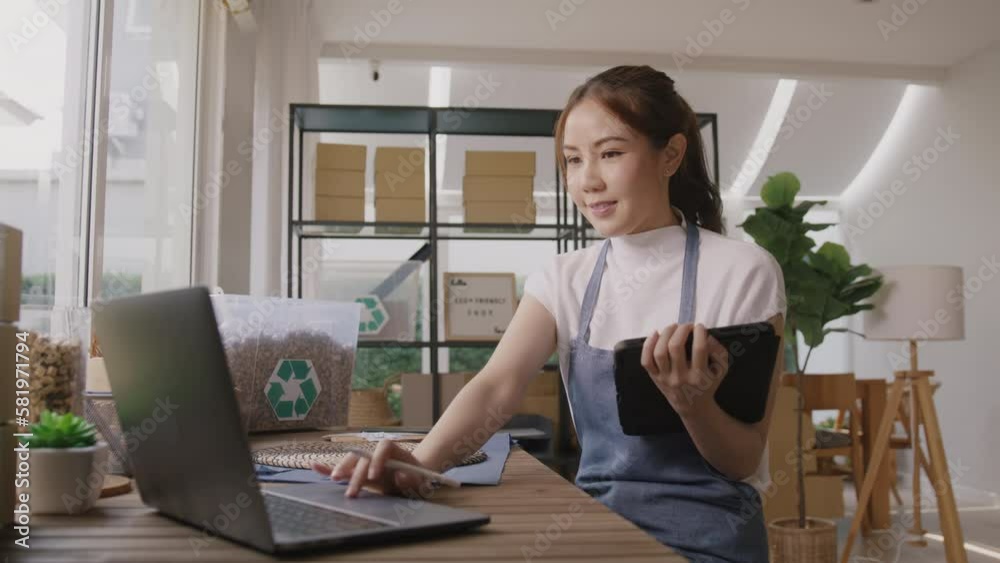 Cloud ERP martech for smart SME. Go green vendor net zero ESG store using easy CRM social media platform on tablet laptop at office. Young adult seller woman asia people happy work at retail box shop. Cloud ERP martech for smart SME. Go green vendor net zero ESG store using easy CRM social media platform on tablet laptop at office. Young adult seller woman asia people happy work at retail box shop.