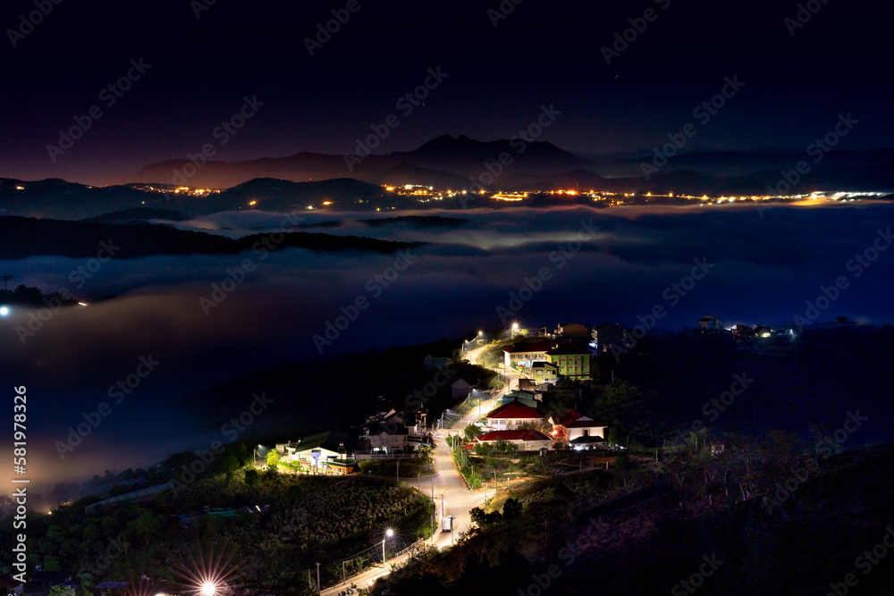 Da Lat City, Lam Dong Province, Vietnam - Da Lat city in fog with brilliant lights in the night. The scene is magical Da Lat City, Lam Dong Province, Vietnam - Da Lat city in fog with brilliant lights in the night. The scene is magical