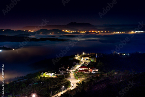 Da Lat City, Lam Dong Province, Vietnam - Da Lat city in fog with brilliant lights in the night. The scene is magical