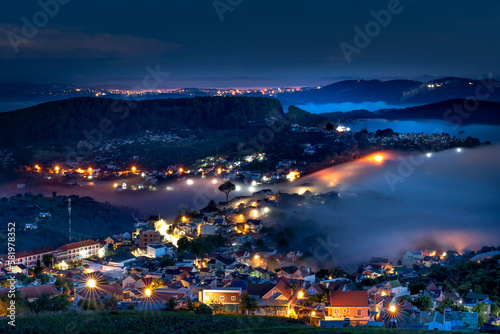 Da Lat City, Lam Dong Province, Vietnam - Da Lat city in fog with brilliant lights in the night. The scene is magical