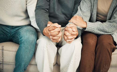 Картината върху платно Trust, love and family holding hands on sofa for comforting embrace, prayer and support together at home