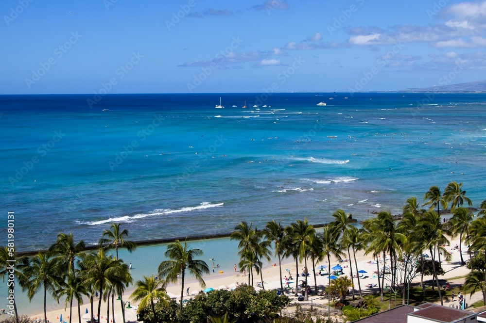 Looking out over Kūhiō Beach from one of Waikiki's many high-rise hotels, as turquoise waves roll in from the Pacific Ocean
