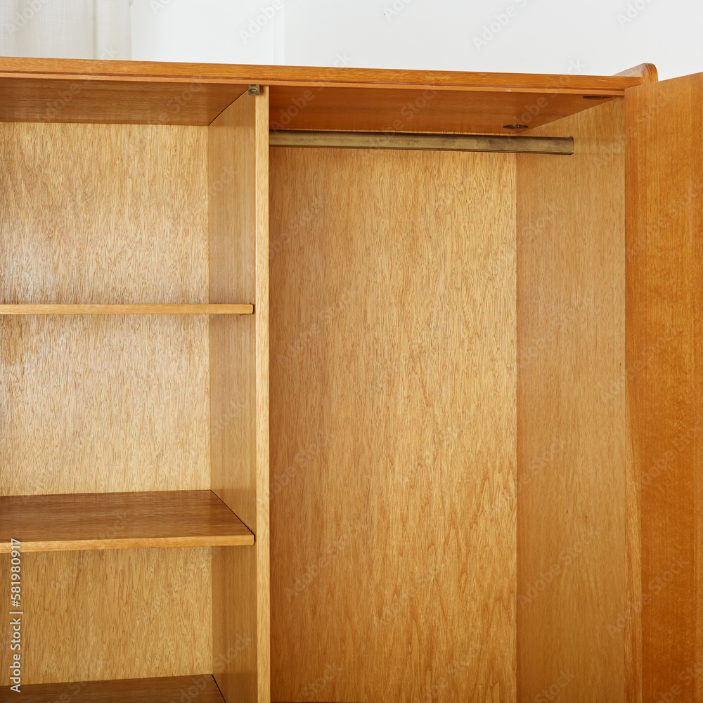 Vintage 1960s oak wood armoire. MidCentury Modern furniture. Interior view of the shelves