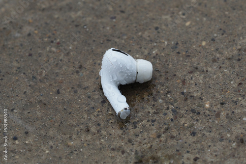 Wet wireless earphone in the Rain.