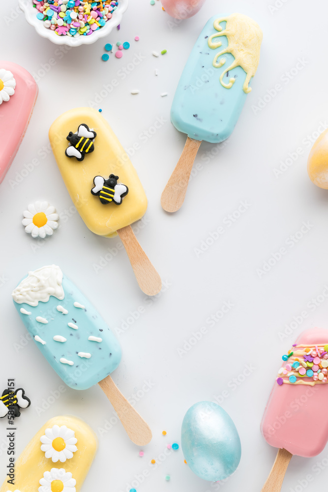 Top down view of several homemade cakesicles, decorated for Easter. Top down view of several homemade cakesicles, decorated for Easter.