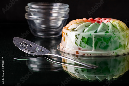 A rainbow coloured fruit flavoured jelly mold dessert, ready for serving.