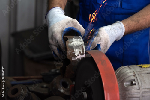 The mechanic was grinding the brake discs and sparks flew out. © Phawat