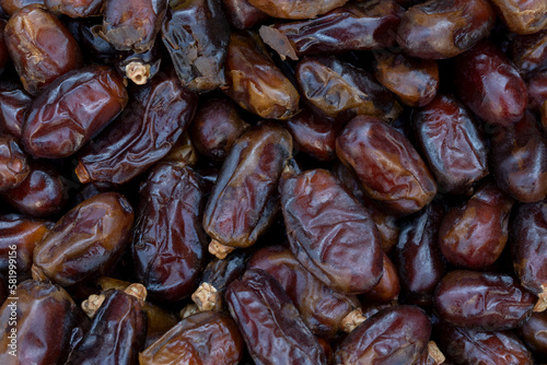 Dates (date palm fruits) displayed on the food market. Close up of dates on market stand. 