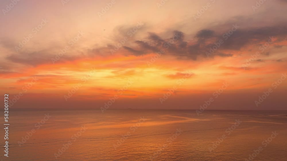 aerial hyper lapse view exotic sweet sky in sunset at Karon beach Phuket..Scene of colorful romantic sky sunset with changing the brilliant yellow sky gradually turned red. .4k video travel concept. aerial hyper lapse view exotic sweet sky in sunset at Karon beach Phuket..Scene of colorful romantic sky sunset with changing the brilliant yellow sky gradually turned red. .4k video travel concept.